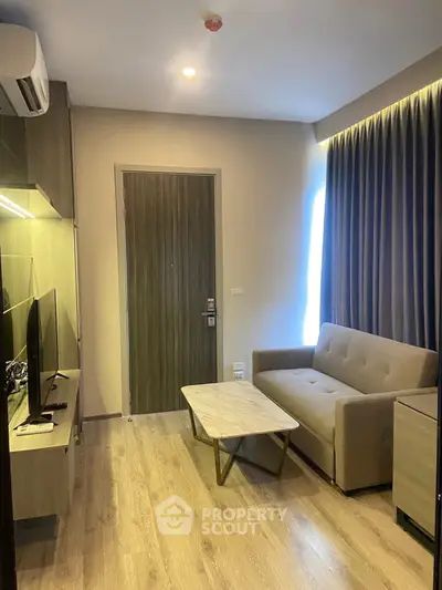 Modern living room with cozy sofa and sleek TV setup in stylish apartment.
