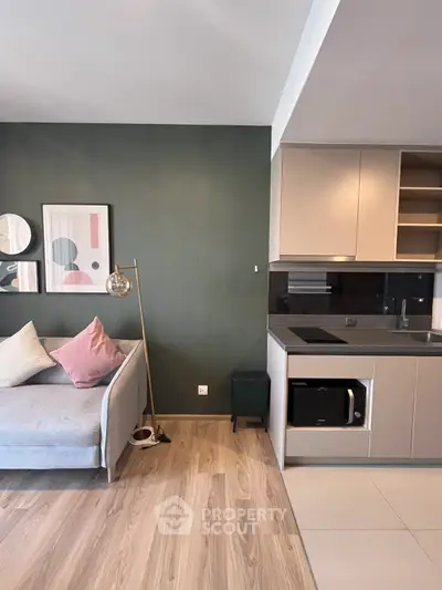 Modern living room with stylish decor and sleek kitchen area