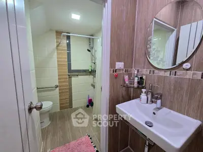 Modern bathroom with stylish wood paneling and sleek fixtures