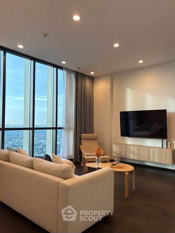 Luxurious high-rise living room with stunning city view and modern decor.