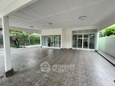 Spacious covered patio with tiled flooring and sliding glass doors