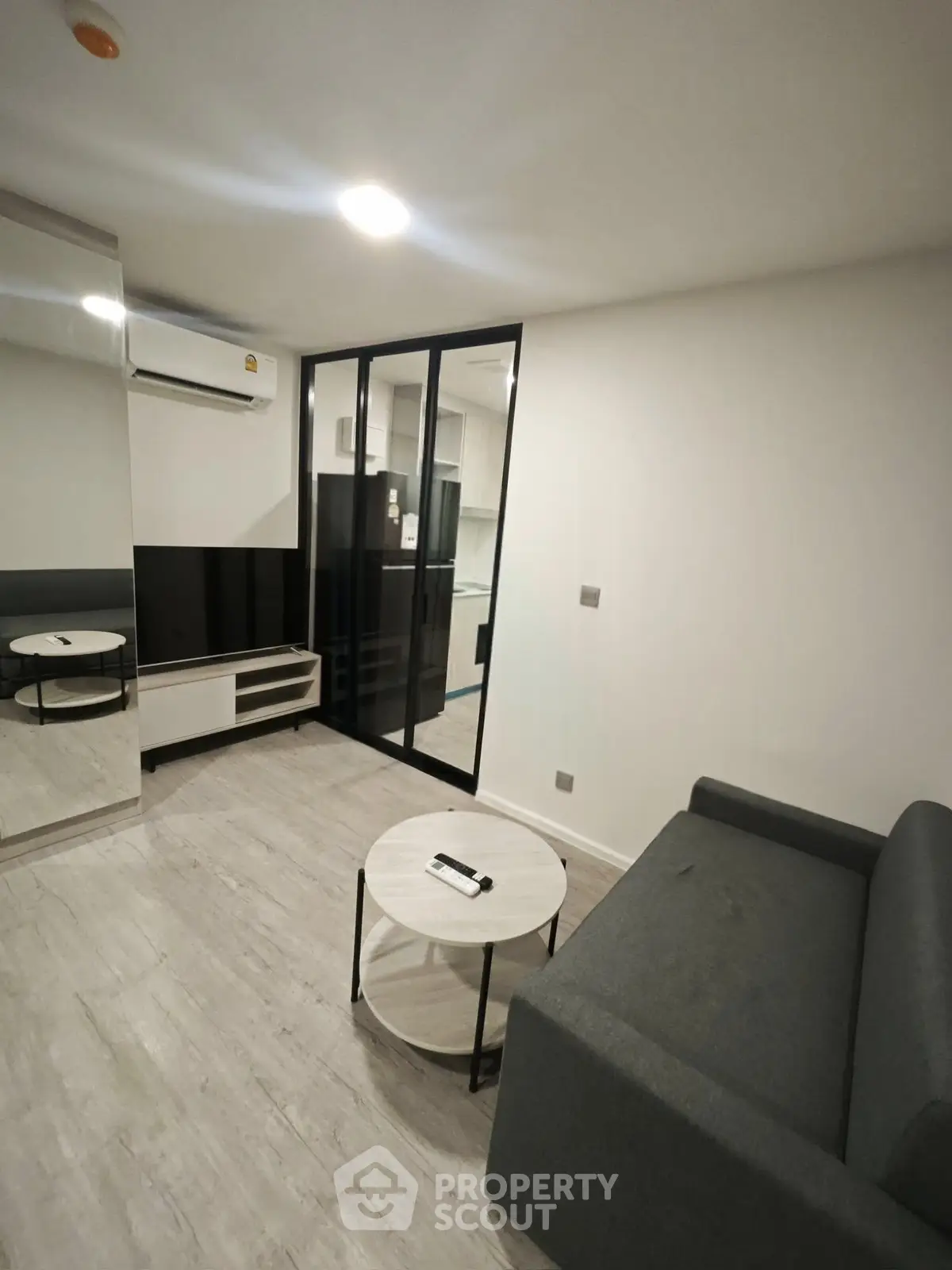 Modern living room with sleek design, featuring a comfortable sofa and stylish coffee table.