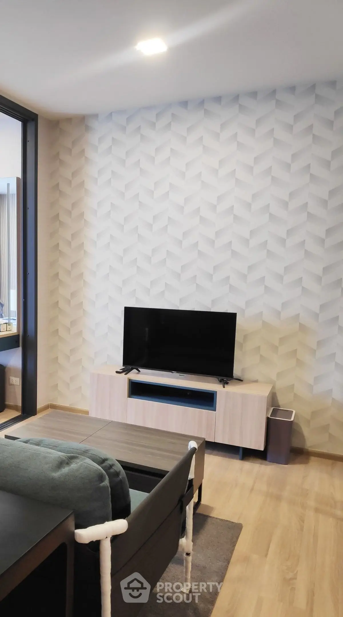 Modern living room with stylish wallpaper and sleek TV setup