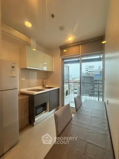 Modern kitchen with balcony view in urban apartment