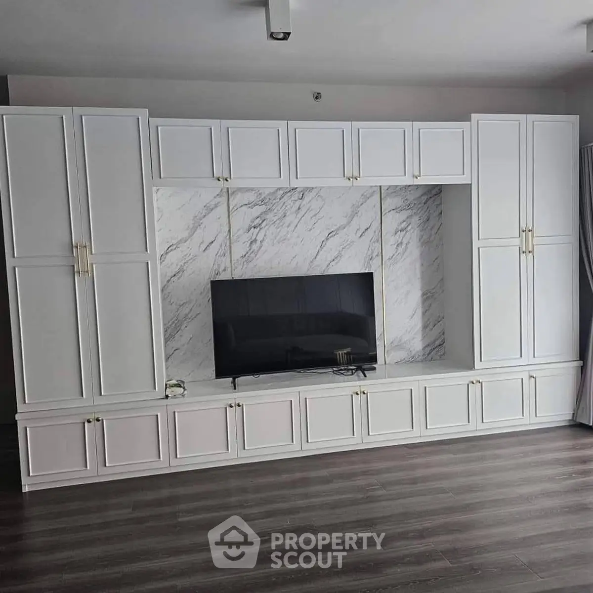 Modern living room with elegant built-in cabinetry and sleek TV setup