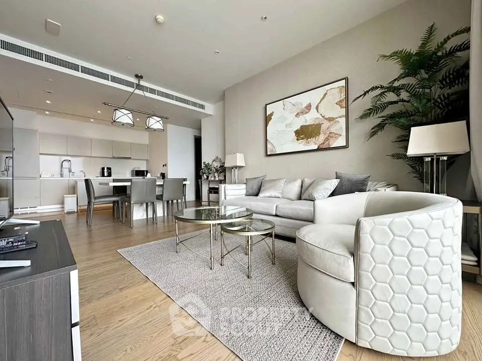 Luxurious open-plan living room with modern furniture and elegant decor in a high-end apartment.