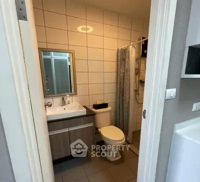 Modern bathroom with sleek vanity and shower in contemporary apartment.