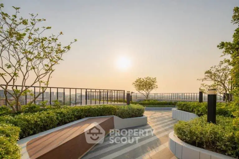 Stunning rooftop garden with panoramic city views and lush greenery at sunset.