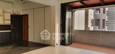 Spacious modern apartment with open layout and balcony access, featuring sleek finishes and ample natural light.