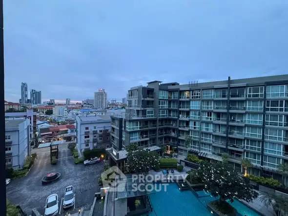 Stunning cityscape view from modern apartment complex with pool and skyline.