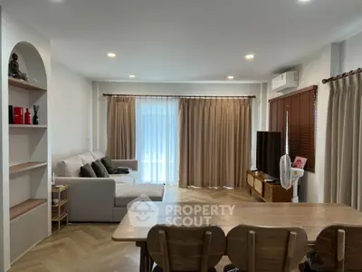 Spacious living room with modern decor and natural light