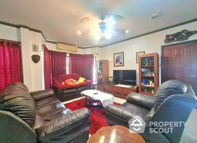 Spacious living room with cozy leather sofas and entertainment center