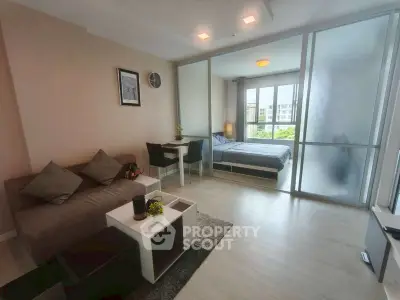 Modern studio apartment with open layout and stylish decor, featuring a cozy living area and bedroom with natural light.