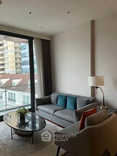 Modern living room with large window and stylish furniture in urban apartment.