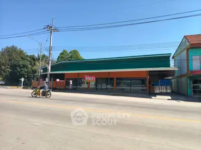 Commercial property with green and orange facade on a sunny day