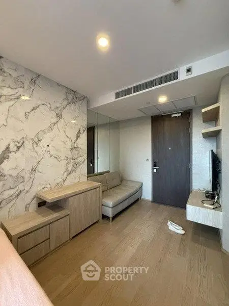 Modern living room with marble accent wall and sleek furniture