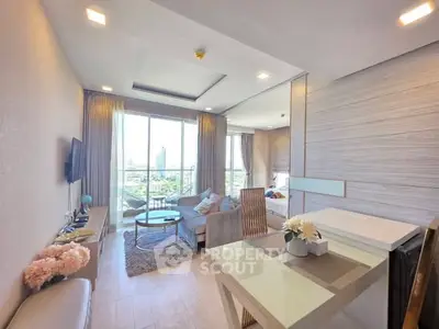 Modern living room with large windows and stylish decor in a high-rise apartment.