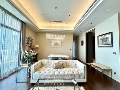 Luxurious living room with elegant chandelier and plush sofa in modern apartment