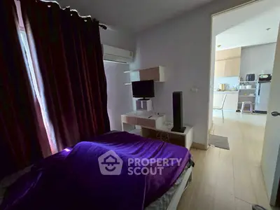 Cozy bedroom with modern decor and open view to kitchen area