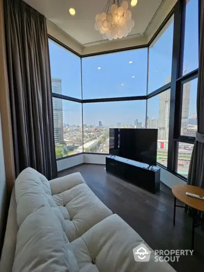 Luxurious corner unit living room with panoramic city view and modern decor.