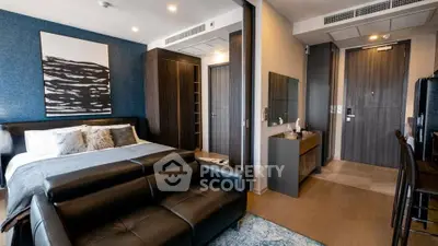 Modern bedroom with stylish decor and leather sofa in a luxury apartment.
