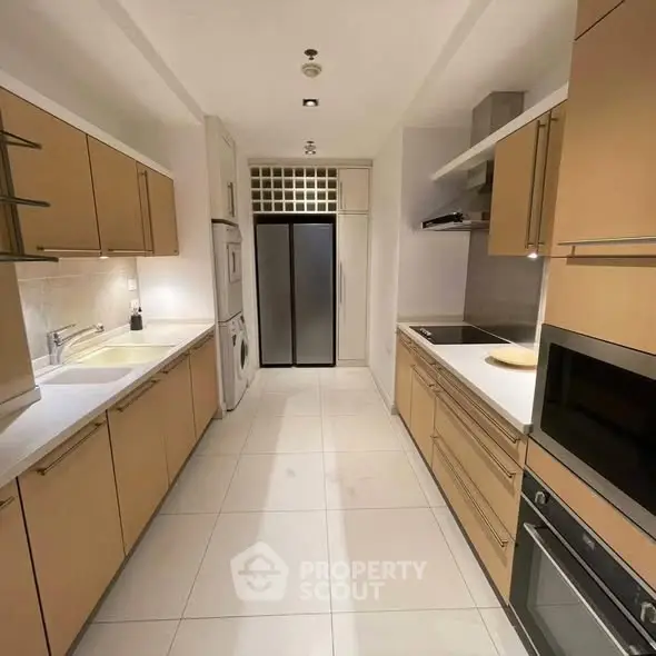 Modern kitchen with sleek cabinetry and built-in appliances in a stylish apartment.