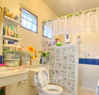 Cozy bathroom with decorative tiles and ample storage space.