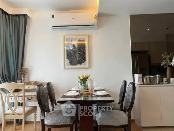 Elegant dining area with modern decor and air conditioning in a stylish apartment.