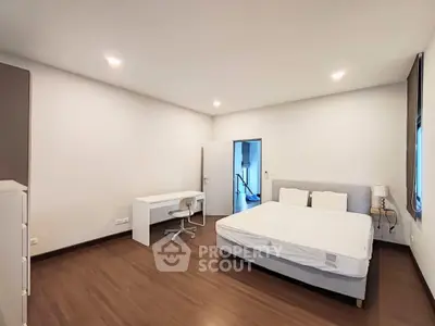 Spacious bedroom with modern furnishings and ample natural light