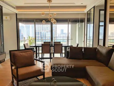 Luxurious living room with stunning city view and spacious balcony in modern apartment.