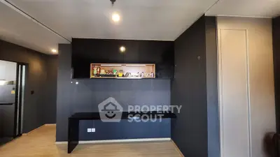 Modern interior with sleek black cabinetry and wooden flooring, perfect for stylish living.