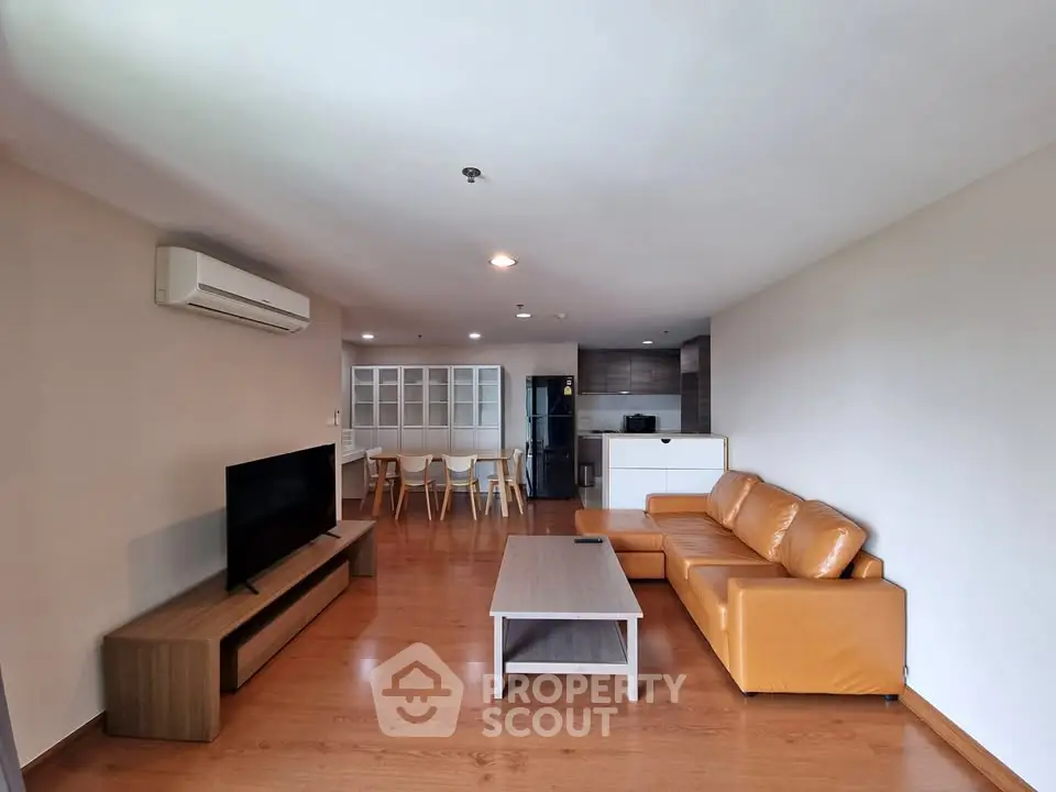 Spacious living room with modern furniture and open kitchen layout