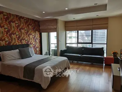 Spacious bedroom with city view and modern decor