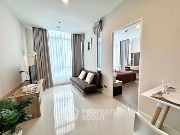 Modern living room with sleek design and natural light in a stylish apartment.