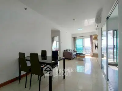 Spacious modern living room with dining area and balcony view