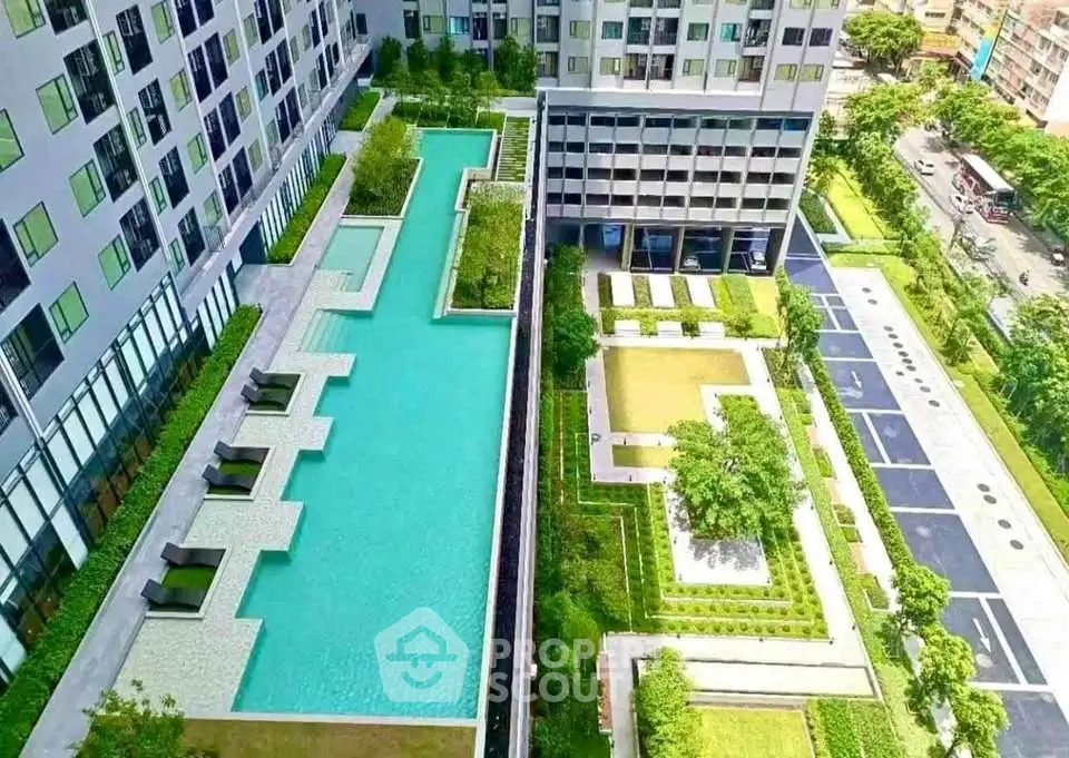 Luxurious apartment complex with stunning pool and landscaped gardens, offering a serene urban oasis.