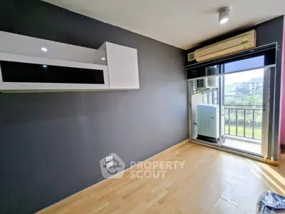 Modern apartment with balcony and air conditioning, featuring sleek storage solutions.