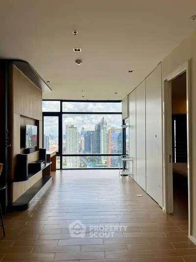 Spacious modern living room with stunning city view and sleek wooden flooring.