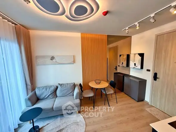Modern living room with stylish furniture and unique ceiling design in a cozy apartment.