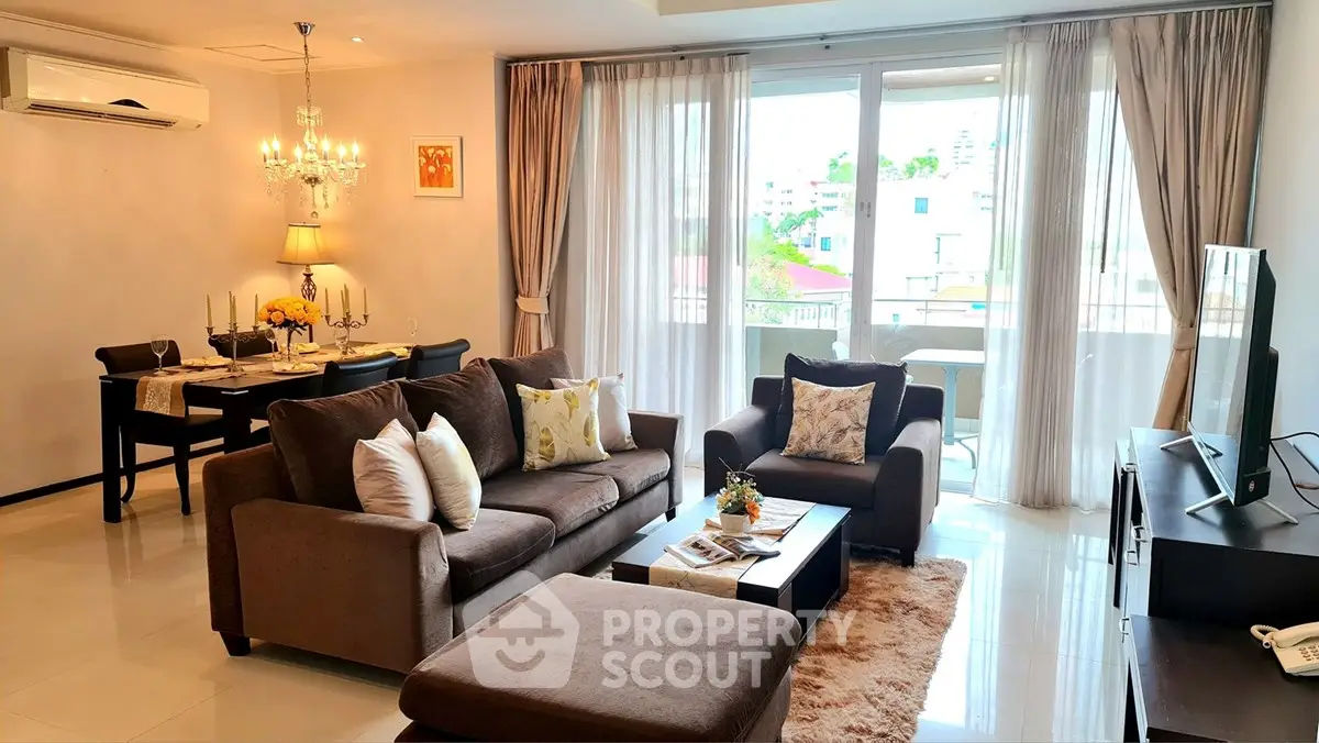Spacious living room with elegant decor and large windows offering natural light.