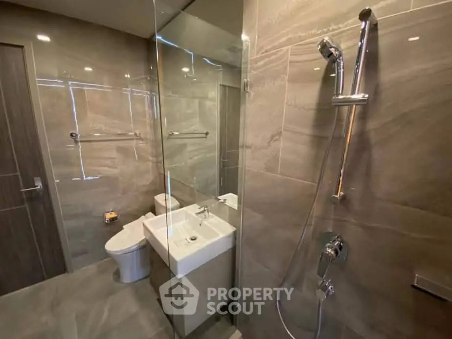 Modern bathroom with glass shower and sleek fixtures