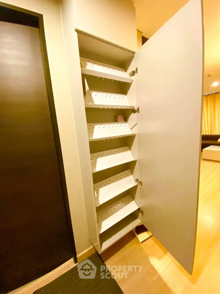 Spacious storage cabinet in modern apartment with sleek design and ample shelving.