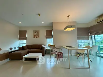 Modern living room with stylish furniture and large windows offering natural light.