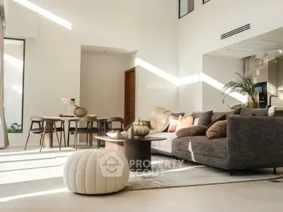 Luxurious modern living room with elegant furniture and abundant natural light.