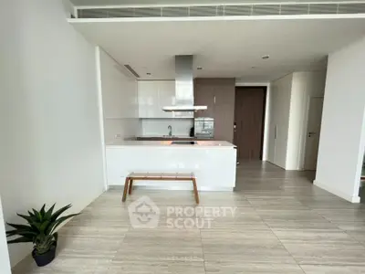 Modern kitchen with sleek design and open layout, featuring stainless steel appliances and elegant flooring.