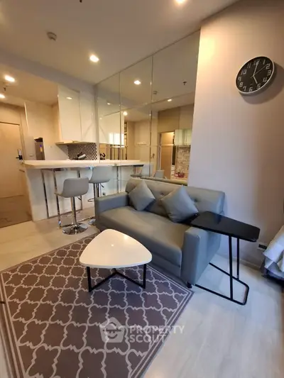 Modern living room with stylish furniture and open kitchen layout in a cozy apartment.