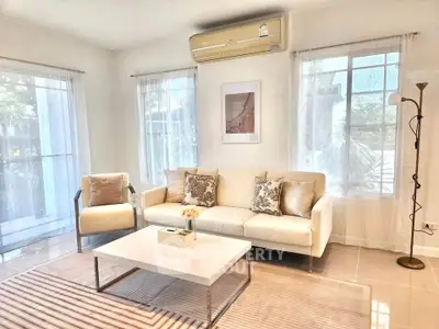 Bright and airy living room with modern decor and large windows.