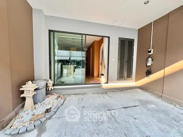 Modern entrance with sliding glass doors and decorative stone elements