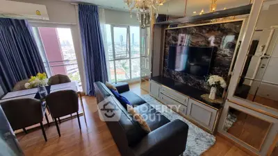 Luxurious living room with city view, elegant decor, and modern furnishings in high-rise apartment.