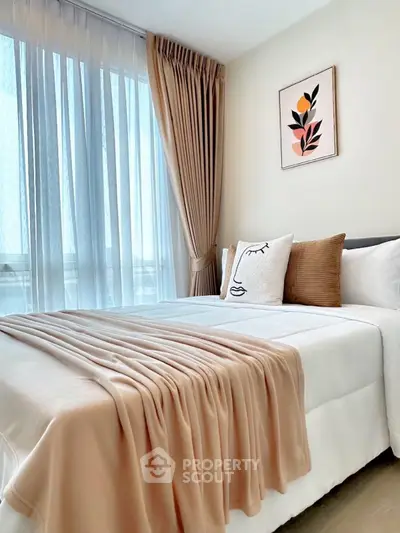 Elegant bedroom with modern decor and large window for natural light